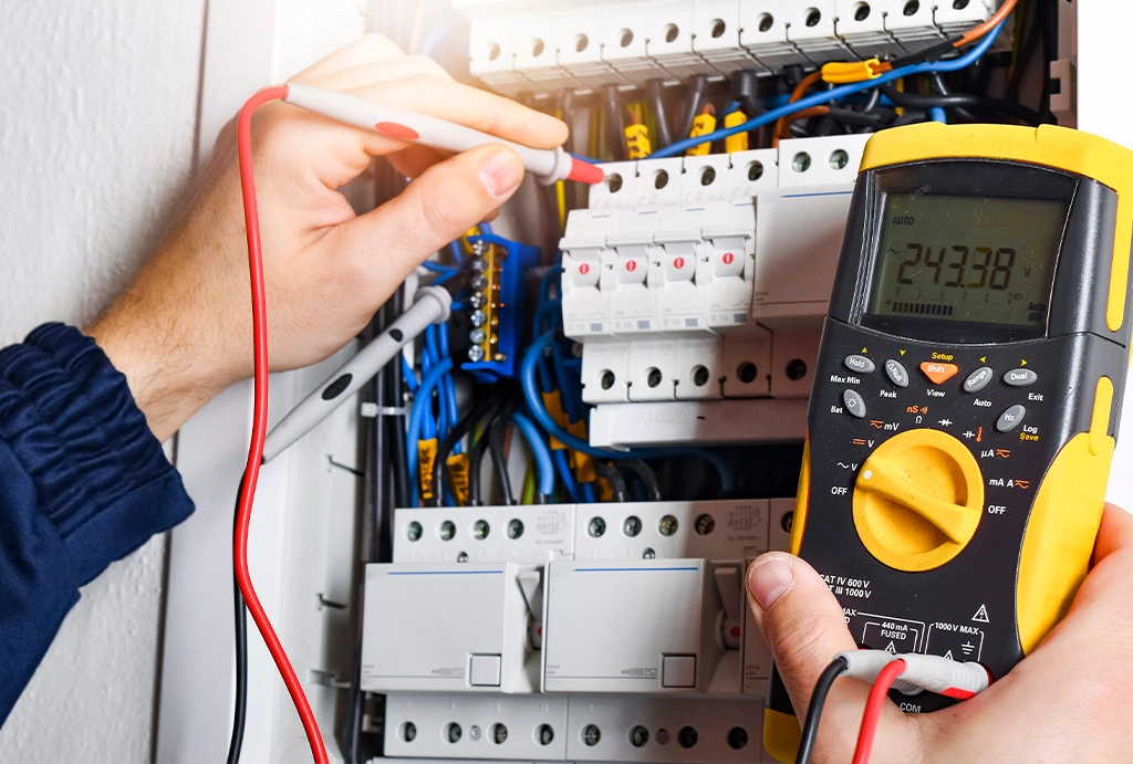 Electrician performing maintenance and repairs on electrical equipment.