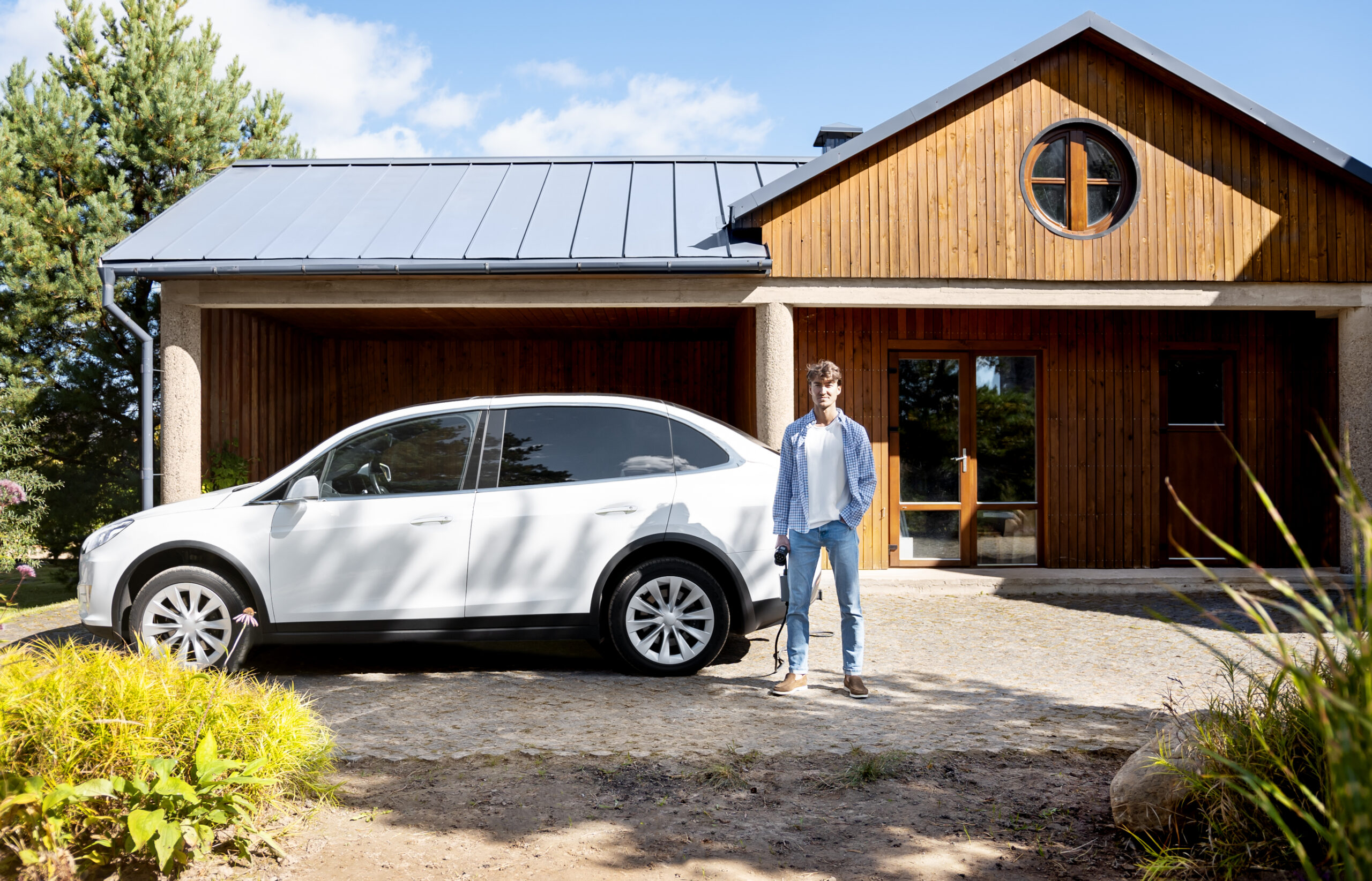 Solar panels and EV charger at home enabling free electric vehicle charging with renewable energy.