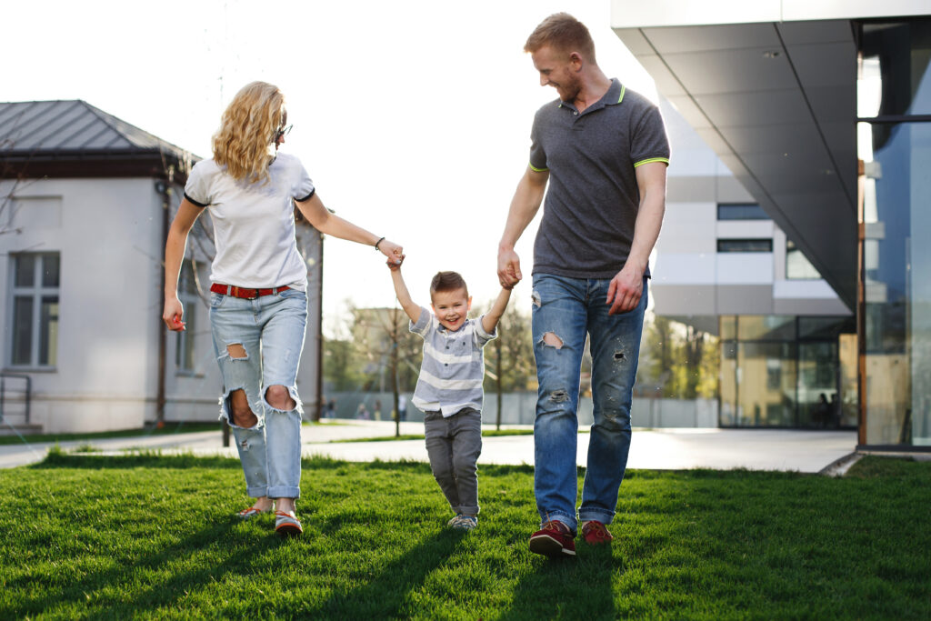 Mom and dad whirl their son and have fun walking outside How to Save Up to 70% on Energy Costs in Adelaide with Solar, Battery Storage, and Efficient Air Conditioning